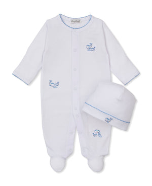 Introducing the Baby Whale Pods Footie with Hat Set from Kissy Kissy: This adorable white footie features blue stitching and charming small blue whale embroidery on the chest, leg, and matching hat—crafted from ultra-soft Pima cotton for comfort. Perfect for your little one!.