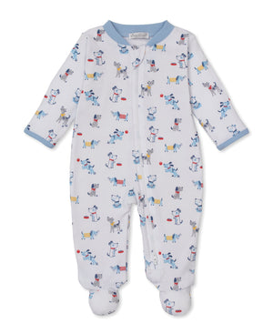 The Baby Boys’ Puppy Patch Zip Footie by Kissy Kissy is a white Pima cotton onesie featuring a colorful puppy patch print. Designed with a convenient front zipper and finished with light blue cuffs and collar, this soft zippered footie is displayed flat on a plain white background.