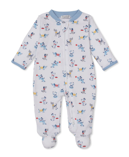 The Baby Boys’ Puppy Patch Zip Footie by Kissy Kissy is a white Pima cotton onesie featuring a colorful puppy patch print. Designed with a convenient front zipper and finished with light blue cuffs and collar, this soft zippered footie is displayed flat on a plain white background.