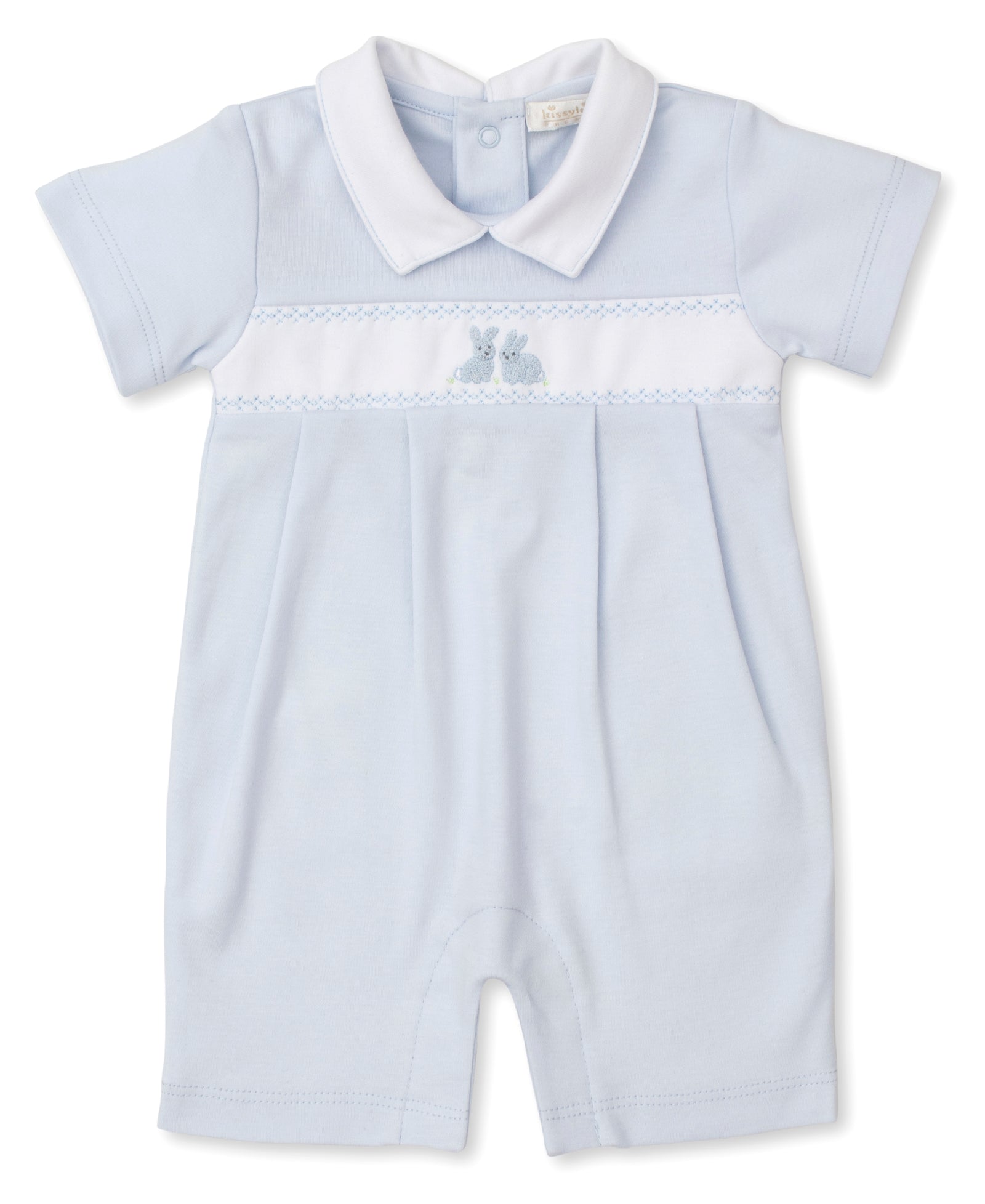 This adorable Kissy Kissy Cottontail Playsuit from the Premier Cottontail Hollows Collection boasts a white collar and sleeve cuffs. Crafted from soft Peruvian cotton, it features embroidered bunnies on the chest and a charming white horizontal band in light blue.