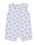 Kissy Kissy Baby Boys’ Whale Pods Sleeveless Playsuit crafted from soft Pima cotton features a charming blue whale and wave pattern on white fabric, with front buttons and blue trim around the arm and neck openings—an adorable choice for summertime adventures.