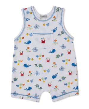 The Baby Boys’ Ocean Antics Sleeveless Playsuit by Kissy Kissy is crafted from soft white Pima cotton with contrasting blue trim and features a charming ocean antics print with whales, crabs, fish, and starfish. A small chest pocket is finished with playful red crab embroidery.