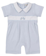 The Kissy Kissy Baby Boys' Premier Springtime Bunny Fun Hand Emb. Playsuit is a light blue short-sleeve Peruvian cotton outfit with a white collar, chest panel, and a hand-embroidered bunny on the front.