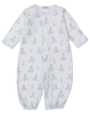 The Kissy Kissy Baby' Giraffe Grace Convertible Gown is a white long-sleeve playsuit with a cute giraffe print and elasticized cuffs, designed for easy comfort and convenience.