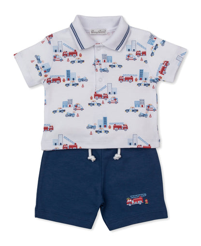 Dress your little one in the Kissy Kissy Baby Boys’ and Boys’ Rescue Raid Bermuda Set, featuring a white collared shirt adorned with a playful firetruck and building print, paired with navy blue drawstring shorts finished with an adorable firetruck embellishment.