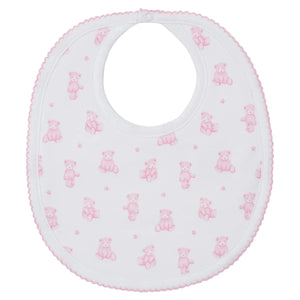 The Kissy Kissy Teddy Bear Time Printed Bib is a white Pima cotton bib with pink trim, adorned with adorable pink teddy bears and tiny flowers—ideal for baby mealtime.