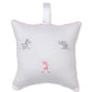 Kissy Kissy SCE Safari Party Musical Pillow—a white square pillow with pink trim, featuring embroidered gray zebra, gray elephant, and pink giraffe designs, plus a handy white hanging loop at the top—makes an adorable baby gift for any nursery.