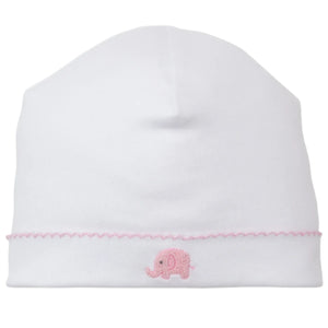 The Kissy Kissy Safari Wild Hand Emb. Hat is a white baby hat crafted from soft Peruvian cotton, adorned with pink stitching and a hand-embroidered pink elephant on the front.