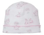 The Kissy Kissy Springtime Bunny Fun Hat is a white Pima cotton baby hat with pink embroidered trim, featuring a delightful light pink and gray bunny and tree print.