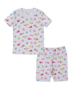 The Kissy Kissy Baby and Kids' Ocean Antics Short Sleeve PJ Set features a white, short-sleeve shirt and coordinating shorts adorned with playful sea creature and flower prints. Made from soft Pima cotton for ultimate comfort, these ocean-themed pajamas are perfect for little dreamers. Shown laid flat on a white background.