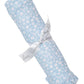 The Kissy Kissy Fall in Bloom Blanket features a white and pink floral pattern, frilled edge, and is tied with a white ribbon printed with gray text. Made from soft Pima cotton, it adds stylish comfort to any nursery.
