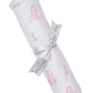 The Kissy Kissy Giraffe Grace Blanket is a white Pima cotton baby blanket with pink giraffe prints, rolled up and tied with a white "Kissy Kissy" ribbon.