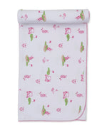 The Kissy Kissy Golf Championship Prt. Blanket is a white Pima cotton baby blanket featuring golf-themed illustrations, green trim, rounded corners, and is partially rolled at the top.