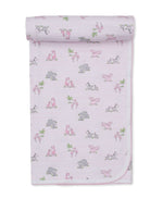 The Kissy Kissy Safari Party Blanket is crafted from ultra-soft Pima cotton in light pink, featuring delicate printed illustrations of hippos, flamingos, zebras, and palm trees with a thin striped pattern and rounded corners.