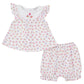 The Kissy Kissy Baby Girls' Sea Shell Magic Sunsuit Set features a white short-sleeve top with ruffled sleeves and matching bloomer shorts in soft Pima cotton, adorned with colorful seashell and starfish prints.