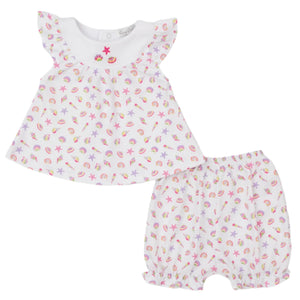 The Kissy Kissy Baby Girls' Sea Shell Magic Sunsuit Set features a white short-sleeve top with ruffled sleeves and matching bloomer shorts in soft Pima cotton, adorned with colorful seashell and starfish prints.