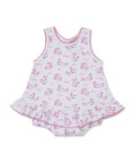 The Kissy Kissy Baby Girls' Whale Pods Bubble is a sleeveless romper made from soft Pima cotton, adorned with a charming pink whale pods print, ruffled skirt, and pink trim at the edges, shown laid flat on a white background.