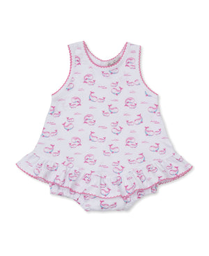 The Kissy Kissy Baby Girls' Whale Pods Bubble is a sleeveless romper made from soft Pima cotton, adorned with a charming pink whale pods print, ruffled skirt, and pink trim at the edges, shown laid flat on a white background.