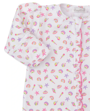 Close-up of Kissy Kissy’s Baby Girls' Sea Shell Magic Zip Footie, made from soft Pima cotton, featuring a sea shell print on white and ruffled pink trim along the zipper.