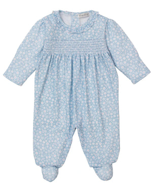 The Kissy Kissy Baby Girls' Fall in Bloom Printed Smocked Footie features a light blue floral print, smocked chest, ruffled collar, and covered feet, all crafted from soft Pima cotton and shown laid flat on a white background.