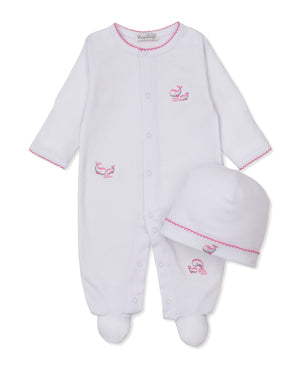 The Kissy Kissy Baby Whale Pods Footie with Hat Set features a cozy footie and matching hat, both made from ultra-soft Pima cotton. Each piece is accented with delicate pink stitching and adorable pink whale embroidery, all presented on a crisp white background.