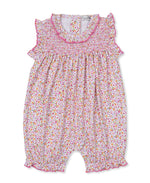 The Kissy Kissy Baby Girls' Blossom Bows Short Playsuit features a charming floral print, smocked bodice, ruffled sleeves, and pink trim. This sleeveless romper offers elastic leg openings and a back button closure for easy changing.