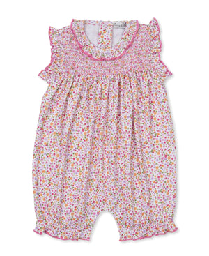 The Kissy Kissy Baby Girls' Blossom Bows Short Playsuit features a charming floral print, smocked bodice, ruffled sleeves, and pink trim. This sleeveless romper offers elastic leg openings and a back button closure for easy changing.
