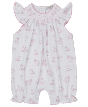 The Kissy Kissy Baby Girls' Springtime Bunny Fun Pink Short Smocked Playsuit features soft Pima cotton, a pink bunny print, ruffled sleeves, a smocked neckline, and delicate pink stitching.