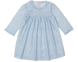 The Kissy Kissy Girls' Fall in Bloom Printed Smocked Dress features long sleeves, a white floral print on light blue, a gathered bodice, ruffled collar, elastic cuffs, and soft Pima cotton for toddler comfort.