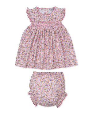 Dress your little one in the Kissy Kissy Baby Girls' Blossoming Bows Dress Set—a soft Pima cotton ensemble featuring a smocked dress and matching bloomers, adorned with pink, yellow, and green floral prints on a white background and finished with ruffled elastic sleeves.