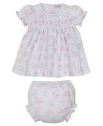 The Kissy Kissy Baby Girls' Springtime Bunny Fun Smocked Dress Set features a white Pima cotton dress with pink bunny print, ruffled edges, and a matching diaper cover—crafted for softness and comfort.