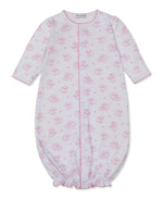 The Kissy Kissy Baby Sweet Sheep Convertible Gown is a long-sleeved white Pima cotton outfit adorned with a charming pink sheep print, featuring a gathered elastic hem and convenient front snap closure.