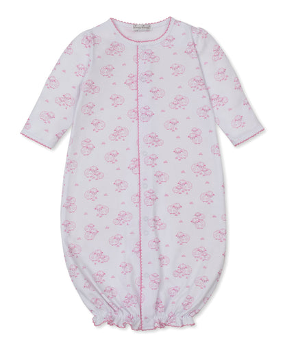 The Kissy Kissy Baby Sweet Sheep Convertible Gown is a long-sleeved white Pima cotton outfit adorned with a charming pink sheep print, featuring a gathered elastic hem and convenient front snap closure.