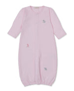 The Kissy Kissy Baby SCE Safari Party Striped Convertible Gown is a light pink, long-sleeve gown made from ultra-soft Peruvian cotton, featuring an elastic hem and small embroidered safari animals—including a giraffe, elephant, and dog—on the front.