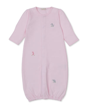 The Kissy Kissy Baby SCE Safari Party Striped Convertible Gown is a light pink, long-sleeve gown made from ultra-soft Peruvian cotton, featuring an elastic hem and small embroidered safari animals—including a giraffe, elephant, and dog—on the front.