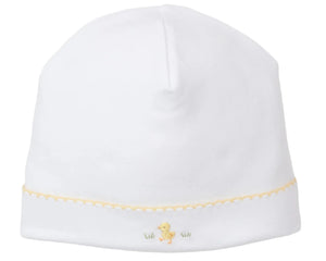 The Kissy Kissy Premier Baby Duckling Hat with Hand Emb. is crafted from soft Peruvian cotton, featuring a delicate yellow scalloped trim and an embroidered yellow duckling accent near the brim.