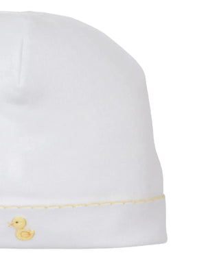 The Premier Duck Pond Paddles White Hand Emb. Hat by Kissy Kissy is crafted from soft Peruvian cotton and features delicate hand embroidery of a small yellow duck near the bottom edge.