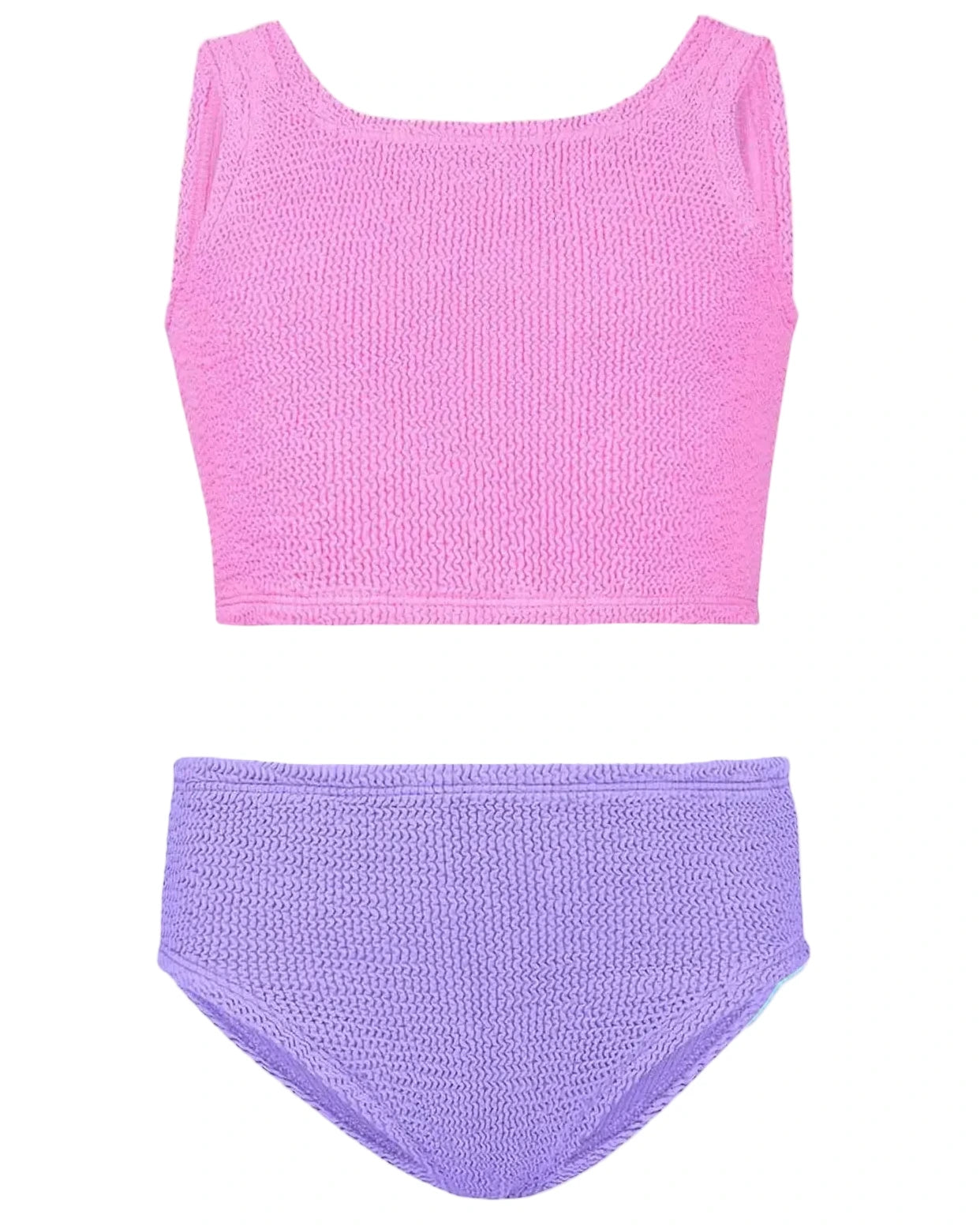 The Hunza G Girl's Duo Lyra Bikini, featuring a textured pink crop top and high-waisted purple bottoms, is laid flat on a white background.