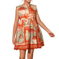 A girl wearing the Hunter Bell NYC Girls' Piper Dress, a sleeveless, knee-length fit and flare dress with an orange, cream, and green pattern featuring geometric and nature-inspired designs.