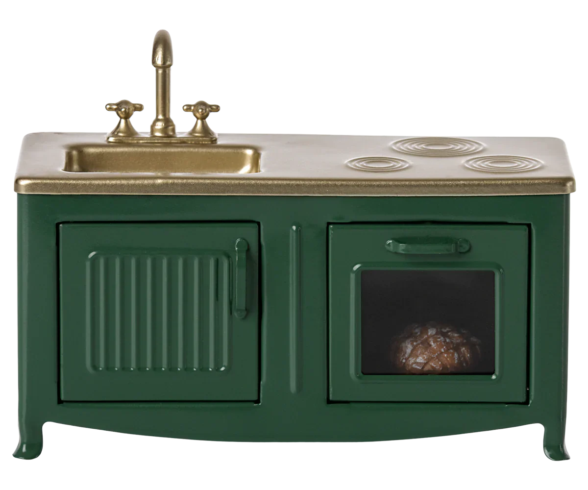 The Maileg Kitchen, Mouse - Dark Green by Maileg is a charming miniature toy kitchen set featuring a dark green sink with a faucet, a stovetop, and an oven with a small item inside, ideal for the Mouse family kitchen.