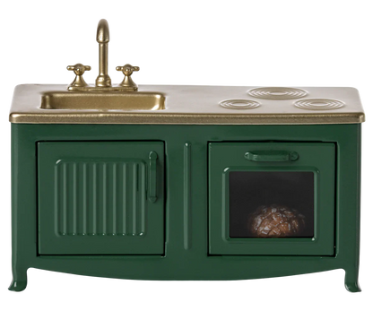 The Maileg Kitchen, Mouse - Dark Green by Maileg is a charming miniature toy kitchen set featuring a dark green sink with a faucet, a stovetop, and an oven with a small item inside, ideal for the Mouse family kitchen.