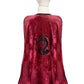 Rear view of a mannequin dressed in a red velvet Great Pretenders Legendary Knight Cape, featuring a black dragon emblem and black trim around the edges, paired with a metallic gold crown from the Great Pretenders collection.