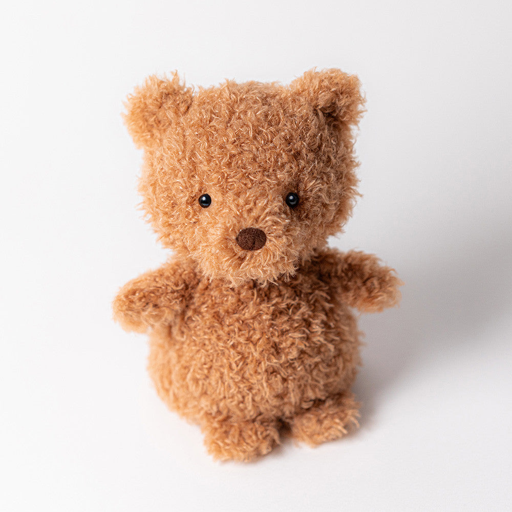 The Jellycat Little Bear is a small, plush brown teddy with round black eyes and a stitched nose, sitting upright on a white background—perfect for cozy comfort.