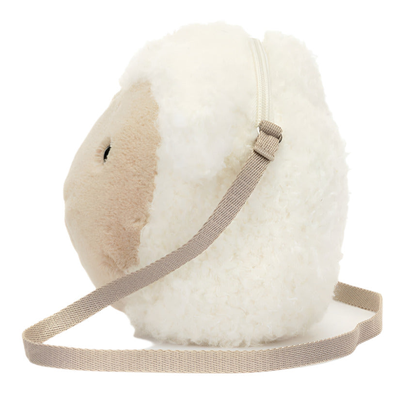 Introducing the Jellycat Little Lamb Bag by Jellycat, a plush sheep-shaped bag with a beige strap, offering a touch of country chic. Shown from the side against a plain white background, it's ideal for those who love unique style.