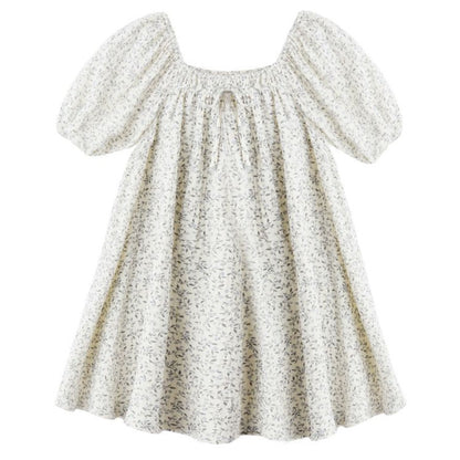 The Rylee & Cru Girls' Sabrina Mini Dress showcases a white floral print, short balloon sleeves, a smocked neckline with front tie, and a loose, flared silhouette for effortless charm.