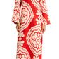 Someone is wearing a lemlem Theodora Column Dress by Lemlem, featuring a red and white pattern with a subtle bohemian silhouette, paired with brown sandals.