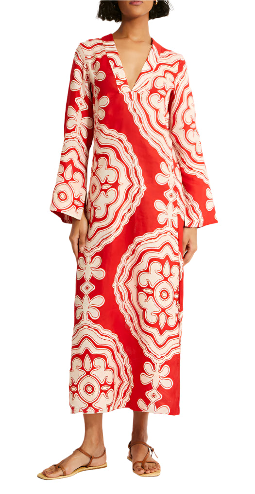 Someone is wearing a lemlem Theodora Column Dress by Lemlem, featuring a red and white pattern with a subtle bohemian silhouette, paired with brown sandals.