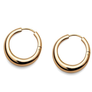 The LIÉ STUDIO Andrea Earrings by Lie Studio, featuring a polished finish, are the perfect gold hoop earrings to elevate any look with their classic style.