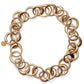 The Laura Necklace by Lie Studio features large interlocking circular links and a small round pendant near the clasp. This adjustable, chunky necklace adds sophistication to any outfit.