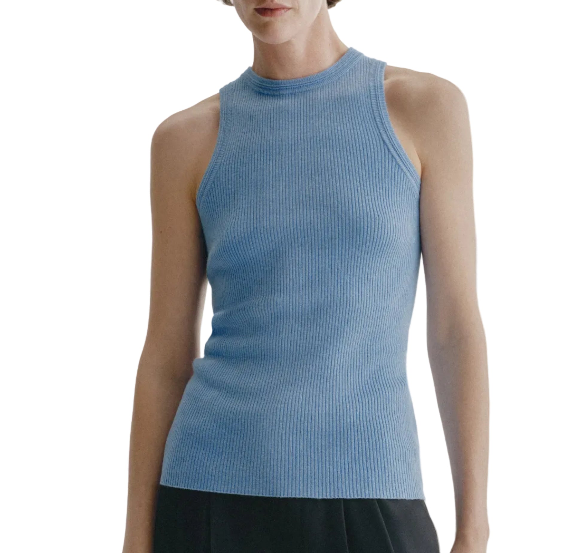 A person wearing the Lisa Yang Amya Tank in light blue—a women’s sleeveless rib knit top with a crew neckline—paired with black pants, shown from shoulders to hips against a white background.